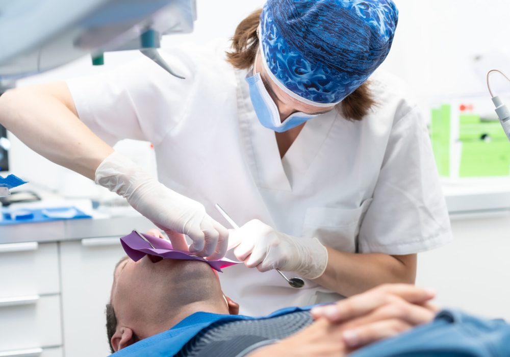 Dental clinic, doctor performing an endodontic operation on a patient